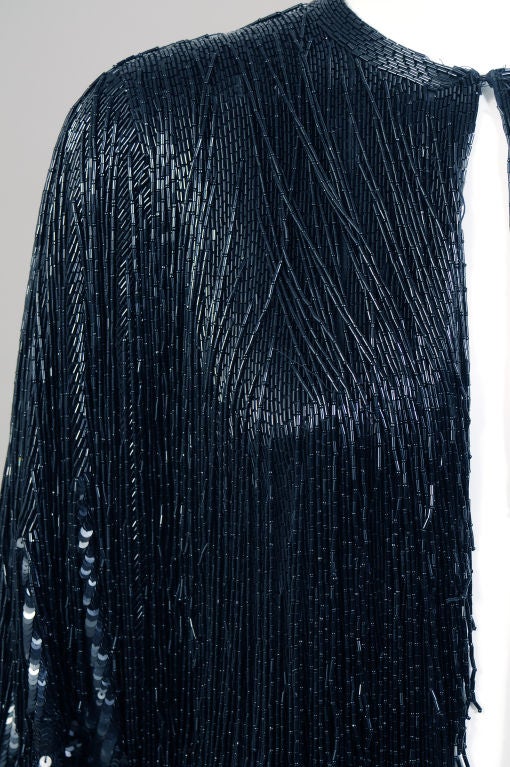 The ultimate beaded jacket from Halston, this jacket is so evocative of the Studio 54 era and Liza Minelli who also owned this design.  it is a very simple shape, a collarless cardigan jacket with a hook and eye closure at the neckline, but Halston