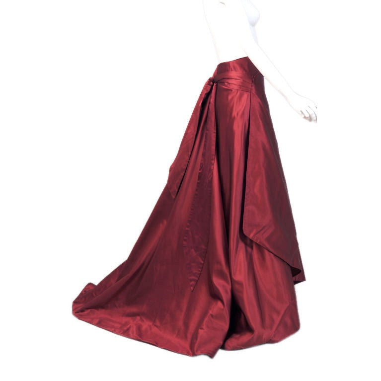 The design firm of Eavis & Brown, London were favorites of Princess Diana and this lovely evening skirt is an excellent example of their classic and elegant work.  The crimson silk satin wrap skirt has a slight train at the back.  In a slightly