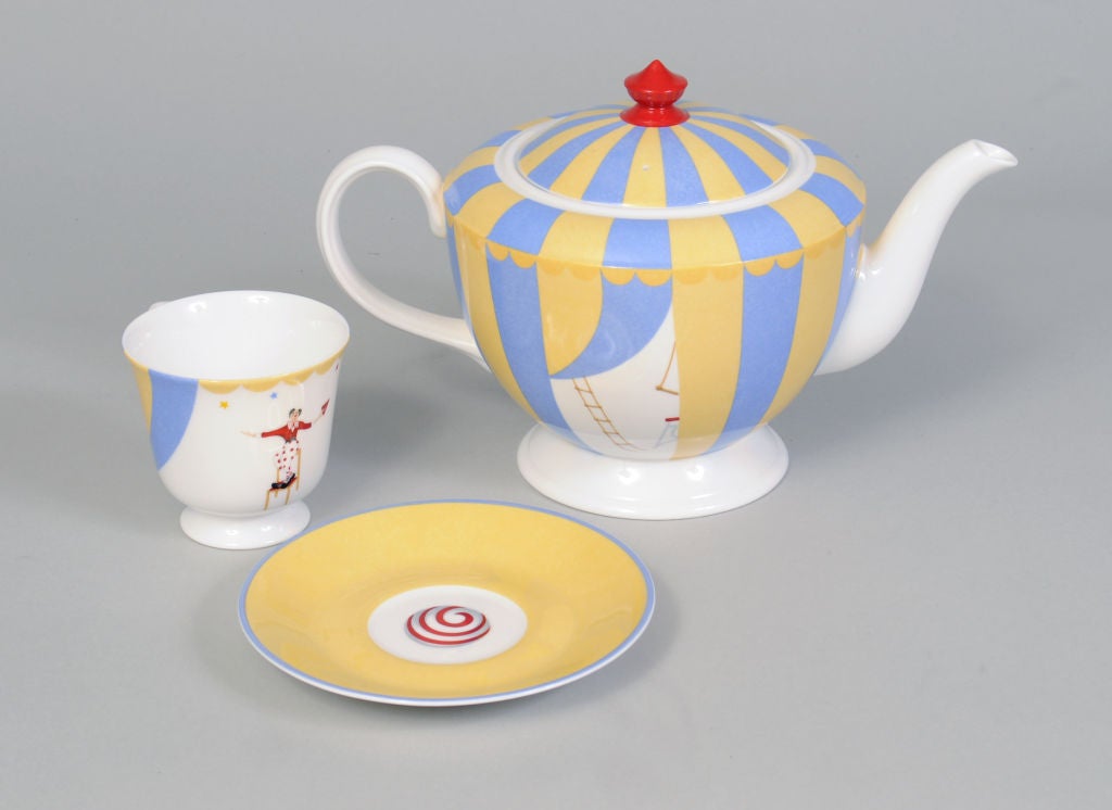 Tea for two under the Hermes Big Top!  What could be more fun?<br />
A lovely porcelain tea pot is decorated with a yellow and blue circus tent, and the curtain is drawn back on one side by the red suited circus ring master.  On the other side we