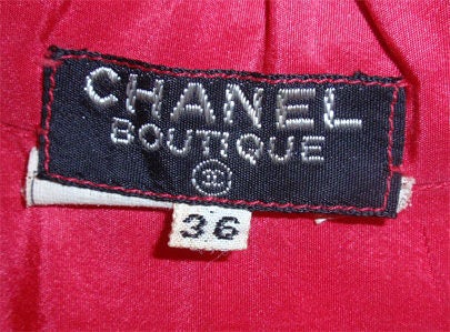 This is a unique and rare, red long sleeve ruffled gown by Chanel, from 1978. It buttons up the front with  large ruffles, a tie around the neck, and ruffles around the generous hemline. 
Size 36

 This red long sleeve ruffled gown by Chanel is