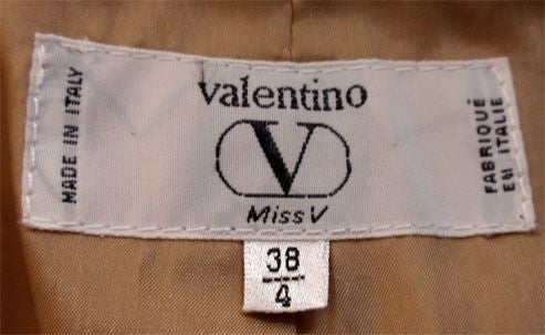 This is a gorgeous camel colored coat by Valentino, from the 1980's. The coat is a wool and mohair blend. It has three large buttons in the front, a 20