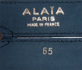 This is a emerald colored suede belt by Alaia, from the 1990's. The belt has brass studs which are broken into two segments, and measures 30