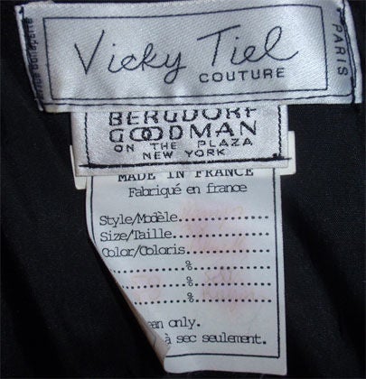 This is a sexy black strapless cocktail dress by Vicky Tiel, from the 1980's. It has a detailed bodice, a knot on the side hip, and a zipper up the back.

Elizabeth Mason

The Paper Bag Princess, Inc.
