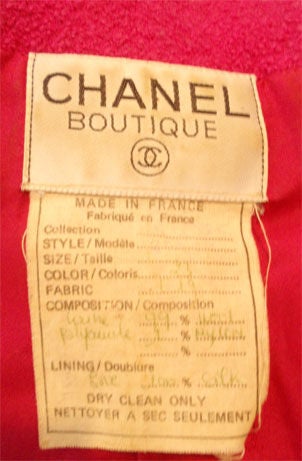 This is an iconic fuschia and black jacket and skirt set by Chanel, from the 1980's. The jacket is double breasted with gold and black logo buttons on the front, pockets, and cuffs.

Please review the measurements provided below to ensure a