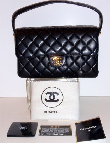This is a unique black quilted leather double sided handbag by Chanel, from the 1980's. It has one 5