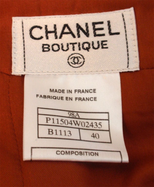 This is a two piece orange, brown, cream, and deep red tweed jacket and skirt set by Chanel, from the 1990's. The jacket has four front flap pockets, three logo buttons up the front, and three on the cuffs. Measures:<br />
<br />
Jacket:          