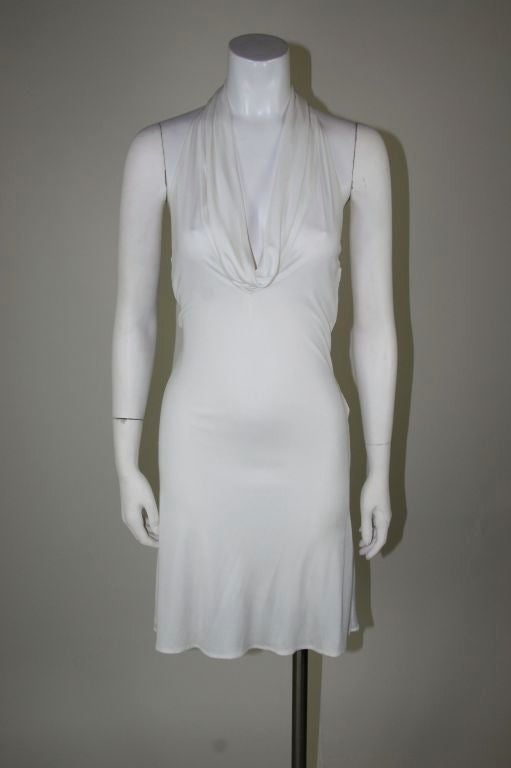 Lifetime Versace white jersey halter cocktail dress, with cowl neck. Leather strap down the back to the buttocks from the neck, with open back. Ruched from the open back to the end of leather strip. Fully lined. <br />
<br />
Measurements:-<br