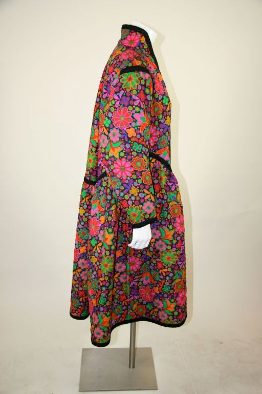 YSL multi-colored floral quilted coat with braided trim on princess seaming. Psychedelic floral print with alternate geometric circular print inside that could be reversible. Russian collection.<br />
<br />
Measurements:-<br />
C.F. to hem -