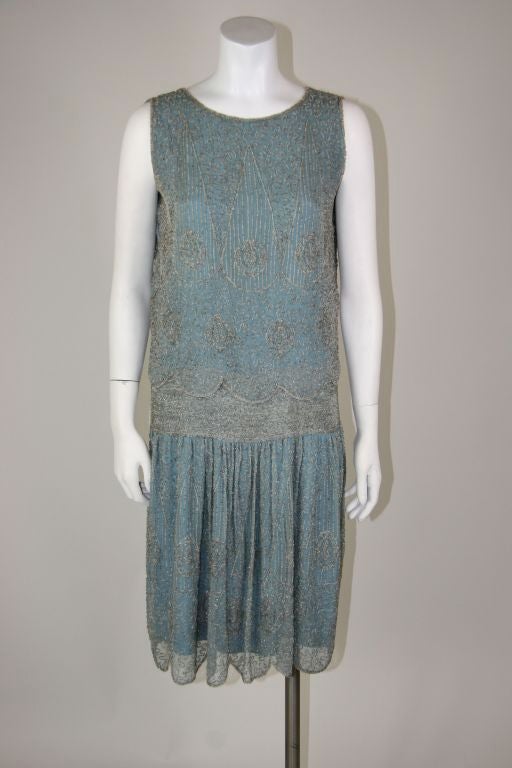 Baby blue beaded 1920s flapper party dress. Detailed bead work all over. Over top with scalloped edge. <br />
<br />
Measurements:-<br />
<br />
Bust - 36