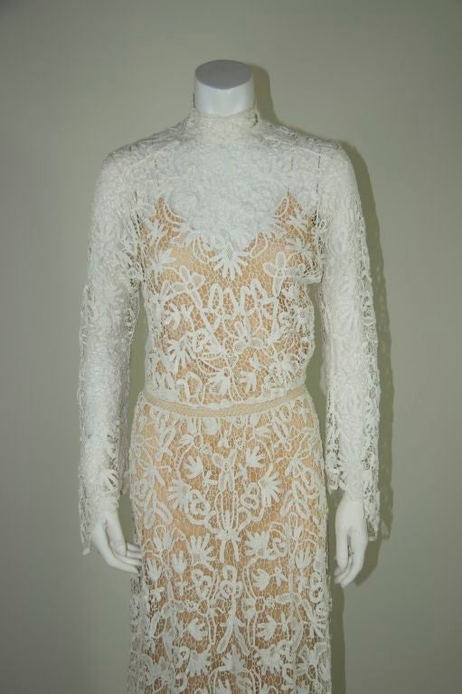 Edwardian all over white tape lace/irish crochet wedding gown. High neck, full length sleeves with bell cuff. Train in the back. (Slip is not included)<br />
<br />
Measurements:-<br />
<br />
Bust - 35