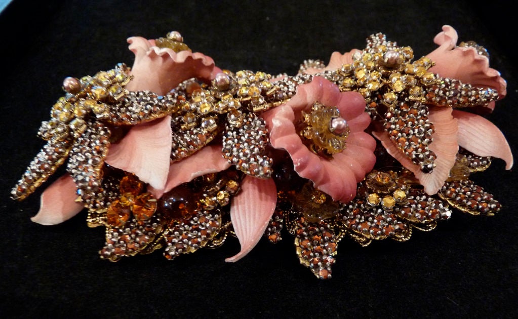 Stanley Hagler large and elaborate floral bouquet brooch. Pink sculpted resin trumpet flowers with rhinestone centers, amongst amber and yellow rhinestone star shaped flowers and pink leaves.  <br />
<br />
Measures 5.25