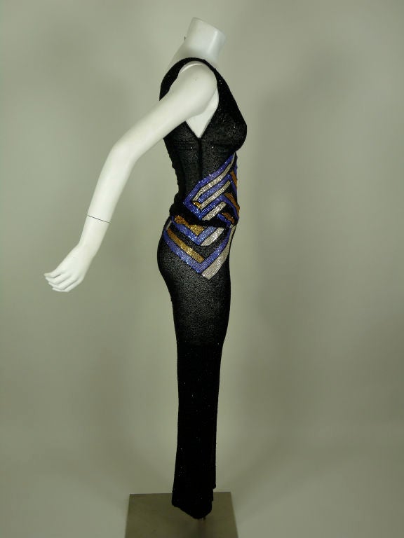 Atelier Versace couture fully beaded super sexy asymmetrical two piece pant suit ensemble. Black with blue, gold and white geometrical flat-back crystal detail. Top is off the shoulder and the strap is on the right shoulder. It gathers down to the