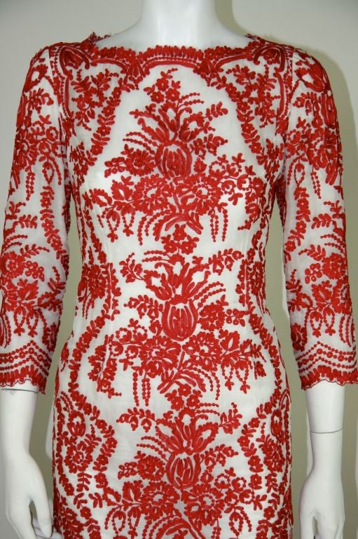 Oscar de la Renta red & white gown. White silk organza with red chain stitch embroidery. 3/4 sleeves. Scalloped detail around the hem, neckline and hem of sleeves. Embroidery mimics chantilly lace pattern.  Fitted through to thighs. Skirt flares