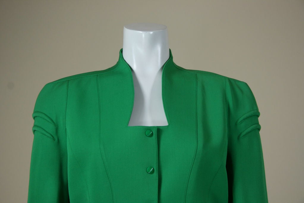 Classic Mugler skirt suit. Jewel tone green. Fitted jacket and skirt. Snap closures on jacket. Defined waist. Full length sleeves. Trapunto ribbed detail on shoulders and around hips. Fully lined. <br />
<br />
Says size 38...please check