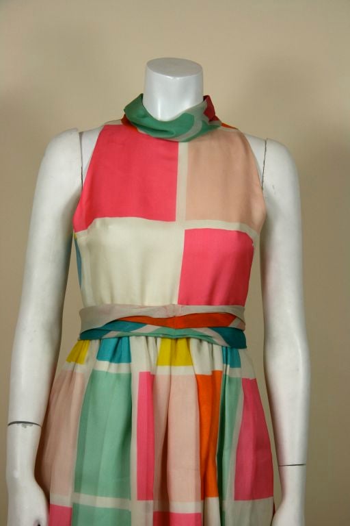 Bill Blass gown. Sleeveless with banded collar. Fitted bodice to fitted waist. Full skirt to floor with detachable sash of same fabric. Pastel & sherbert colored squares all over. <br />
<br />
Measurements:-<br />
Bust - 34