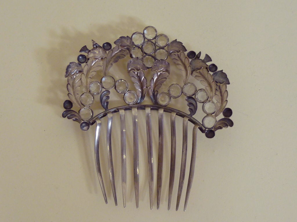 Circa 1900 silver comb with sparrow and leaf motif and prong set brilliant clear crystal paste rhinestones. <br />
<br />
Measurements--<br />
4.25