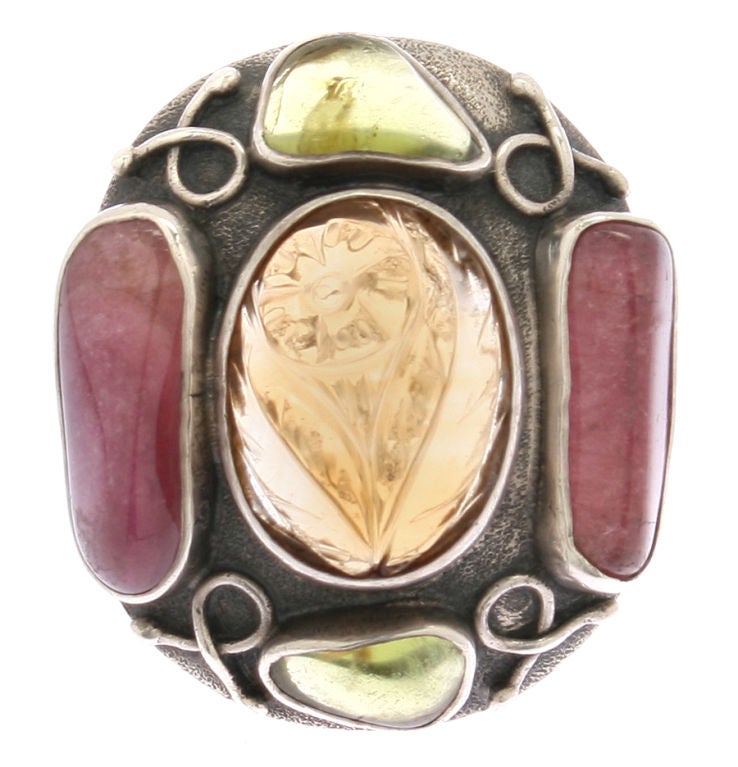 This is an interesting and large ring by Fred Skaggs consisting of semi precious stones.  The central stone is carved.   The ring is a size 5. and could be made larger.<br />
The face of the ring measures 1 1/4