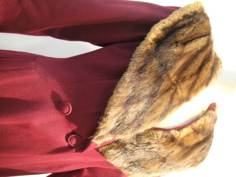 Lovely 1940's burgundy wool coat: double breasted with with a fitted waist and flared hem, it is topped with a fab 40's style large shawl style mink collar! <br />
<br />
Sleeve length 24