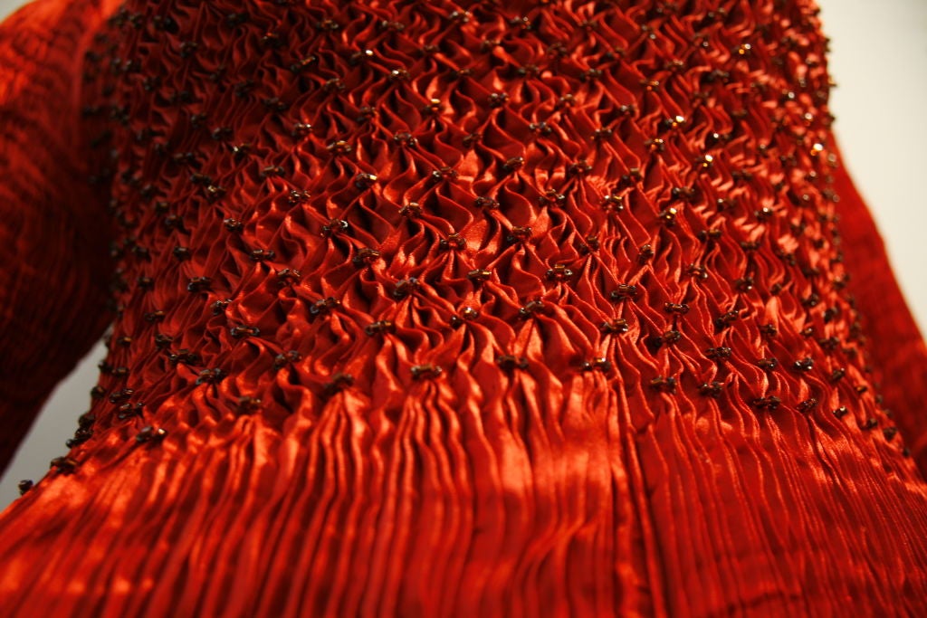 This amazing 80s Charles and Patricia Lester micro-pleated Fortuny-style flaming red silk gown hugs every curve! Beaded smocking of the bodice pleats adds interest to this fabulous piece!  <br />
<br />
Approx Shoulder width 15-16