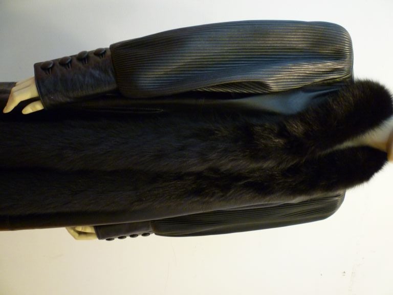 This fantastic 1980s leather trench by Rocco D'Amelio for DERO has incredible personality!  The shoulder and sleeve detail speak volume! Trimmed with luscious black fox, and complete with four button functional cuffs!  <br />
<br />
Marked size