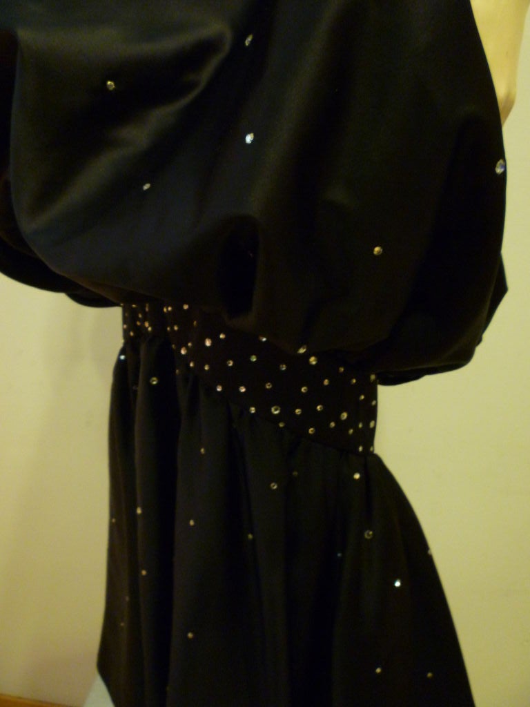 This 1970s rhinestone studded black satin fishtail bubble gown is styled after a 1950s Hollywood silhouette and is bubbled and banded at the knee. Silk blend Satin. Originally sold at Harriet Kassman department store in Washington DC.  Marked size 6.