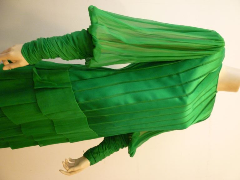 This 1980s Galanos gown shows his masterful construction techniques superbly!  The bodice is constructed of silk satin ribbon laid over chiffon, the chiffon balloon sleeves have dramatic ruched cuffs and the skirt is made from individually pieced