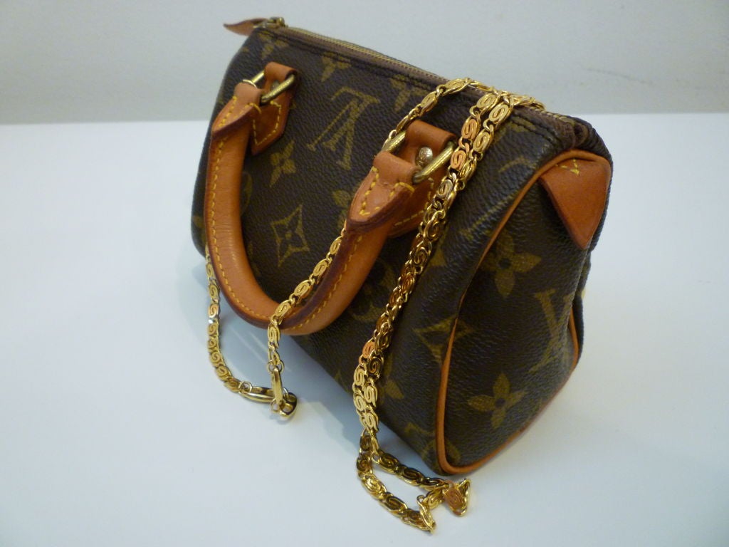 An unusual classic from the 80s! Mini Monogram Vuitton bag in signature brown leather and monogram canvas is a limited edition and has a gold-tone chain shoulder strap.