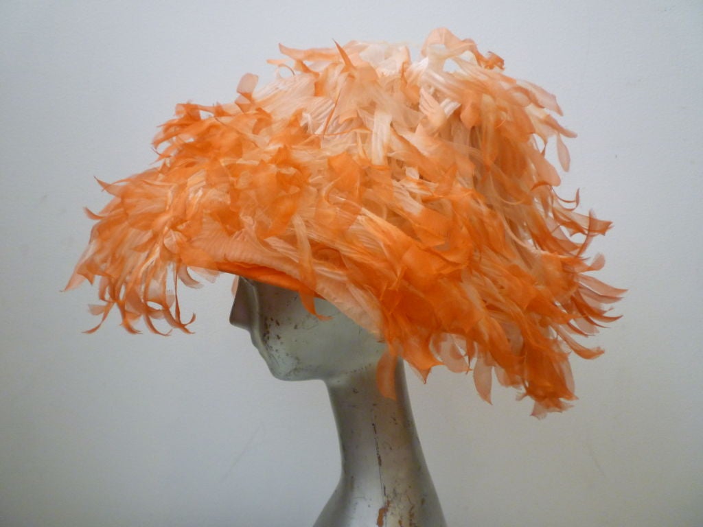 Lovie!  This is a real showstopper of a whimsical hat, extravagantly embellished with silk chiffon petals tipped in an attractive peach color!  It's base is constructed of stiffened lace buckram. From The Emporium.