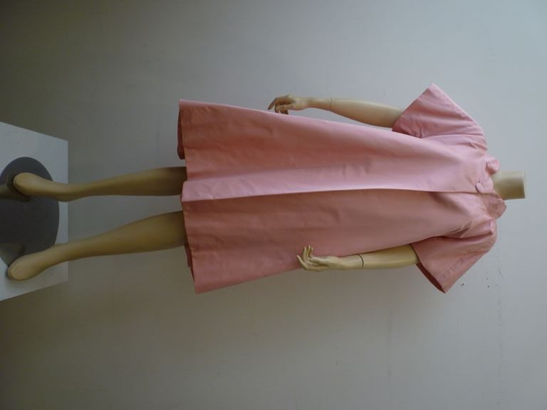 Fantastic Fernando Sarmi 1960s pink silk baby doll opera coat has cropped sleeves, a wonderful trapeze shape and a deep pleated neckline with a bow in back!  Sarmi for I. Magnin!
