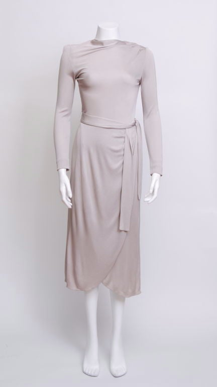 Late 40's/early 50's silver colored silk jersey long sleeve dress with tie belt and shawl, with pinch pleats at shoulder and waist. Side slit to hip, designed to look like a wrap dress.