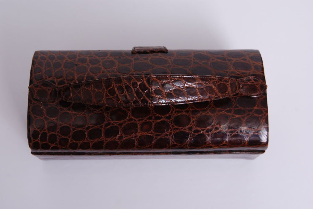 chestnut brown alligator hard box purse with mirror inside.