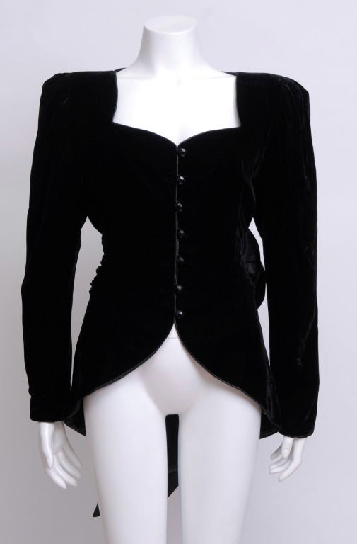 Jean-Louis Scherrer black velvet blazer with heart shaped bustline, pouf shoulders, black shiny plastic jem stone-cut buttons, extra large bow sash at back, fully lined.