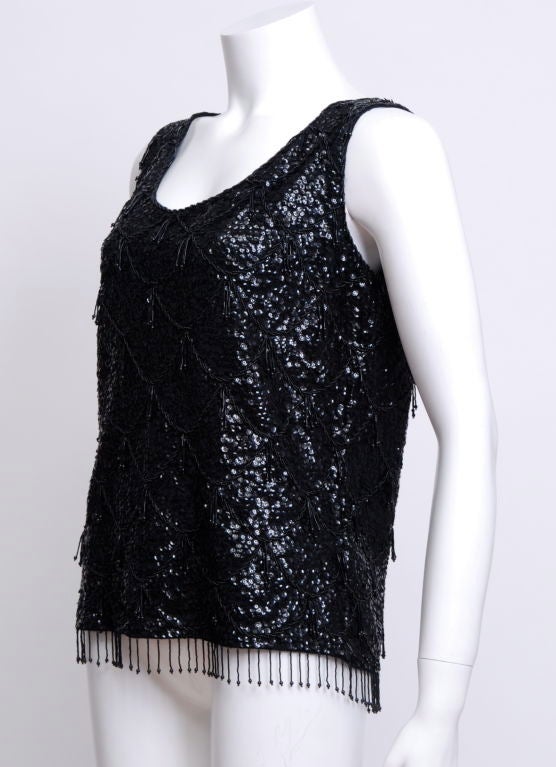 Black sequin and beaded tank top, with a scalloped design, hanging black glass beaded fringe throughout and at bottom. Zipper at back. Fully lined in black silk.Loose fit through body.
