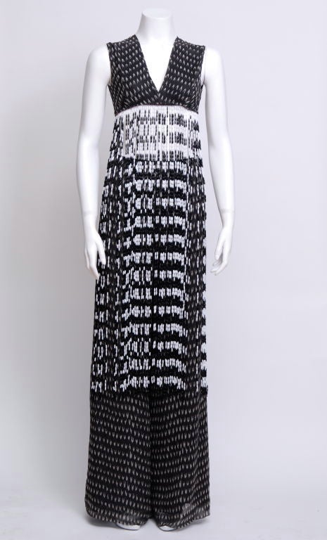 Two piece, black with small abstract pale gray pattern, wide leg pants lined in black silk, the top piece has a short bodice attahced to black and white long plastic bead strands. Fringe length 34 in.

Born: Dorothea Naomi Seale in Jerusalem, 24