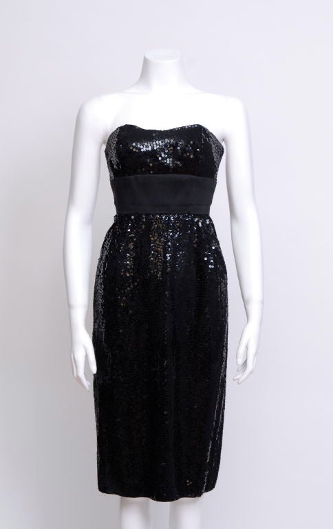 Stapless silk charmeuse dress with all over black sequins on the bust and skirt, mat silk band waist. Kept in pristine condition.<br />
<br />
Norman Norell (born Norman David Levinson April 20, 1900 in Noblesville, Indiana - died in New York,