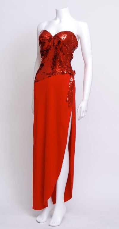 Stunning Loris Azzaro Strapless Sequin and silk gown, featuring a slit up the leg to the hip and a Sequin bow attached to the red sequin bodice. The bodice has a built in bra with cups. Kept in pristine condition. <br />
<br />
Loris Azzaro
