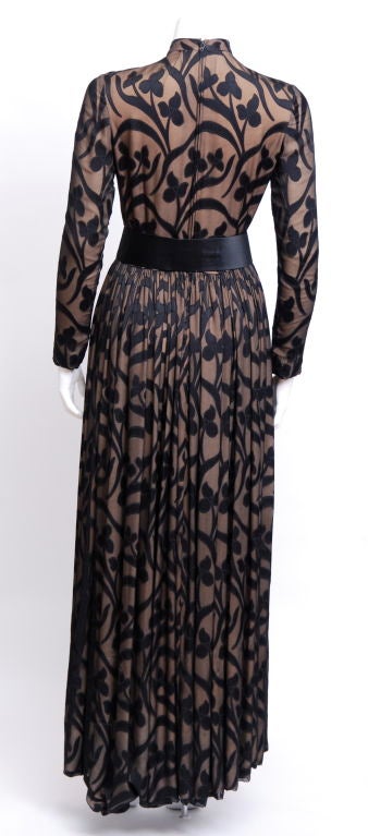 Stunning two layer gown with an underlay of cream silk and a top layer of sheer black chiffon with opaque shiny silk floral motif throughout. The silk satin belt can be worn with or without.