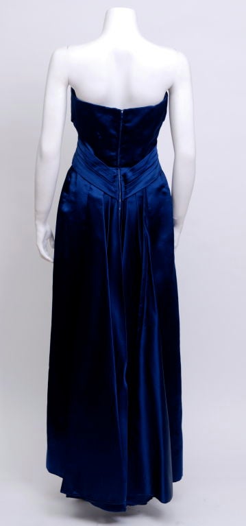 Stunning blue silk satin empire strapless gown with tulip bust. The back has two piece folded train. The dress is fully lined with boning at the ribcage.