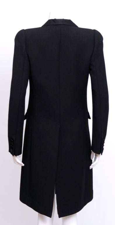 Wool grosgrain, single breasted tuxedo coat with shiny collar, silk button, 2 pockets, lightly padded shoulders and vented back.

Fully lined.