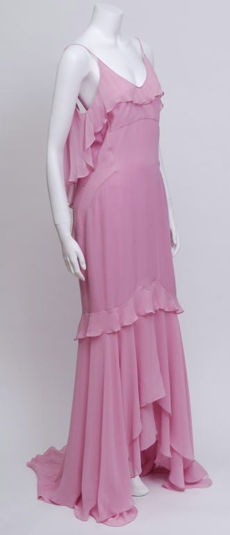 YSL rose colored silk chiffon gown with spaghetti straps, empire waist, layered flounced hemline and a flounced handkerchief hem. Shaped seaming at waist. Unworn, tags attached.<br />
Y.S.L.  1936 -2008<br />
Yves Saint Laurent was the most