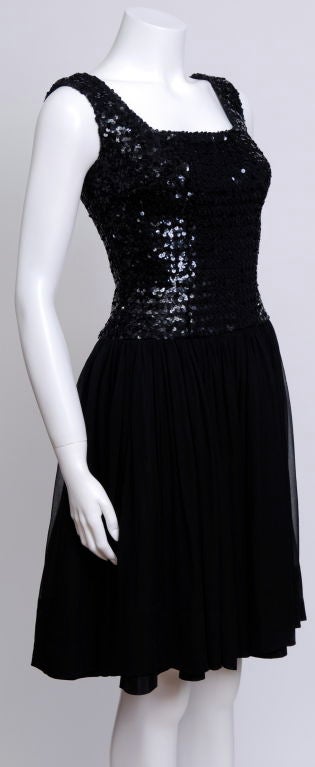 This 60's cocktail/party dress features a square neckline, sequin bodice, and a flowing silk chiffon skirt.