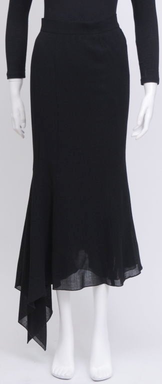 This Chanel light weight wool maxi skirt features a handkerchief hem and stylish side flounce.