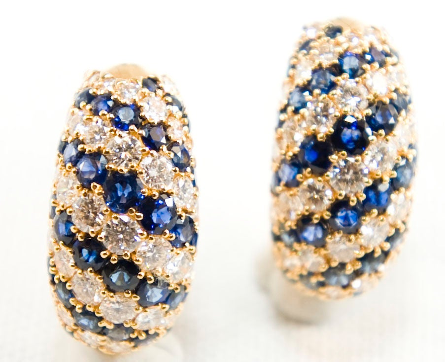 Beautiful quality and make.   18k Yellow Gold, Sapphire and Diamond Loop Earrings with diagonal stripes.
There is 7.44 tcw of sapphires and 4.58 tcw of diamonds.

French Marks and Serial Numbers (No Evident Signature)
