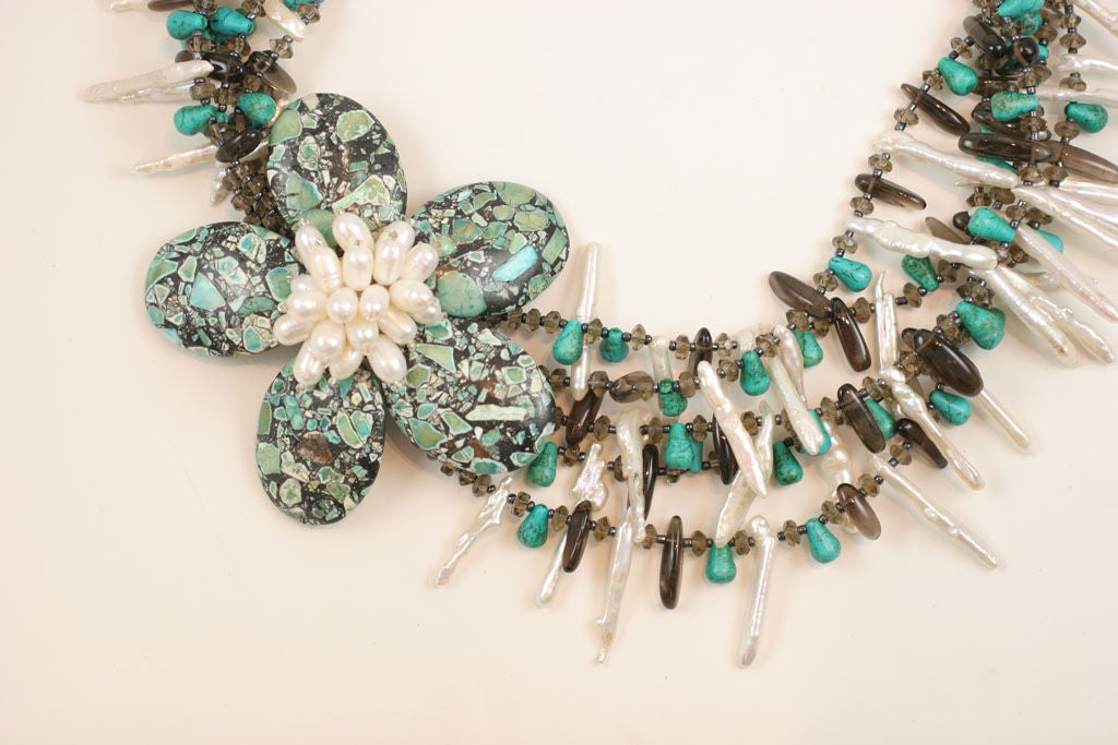 Huge artisan made, multi-strand necklace composed of fresh water pearls, gray crystals, turquoise and stone. The flower on the necklace measures 4