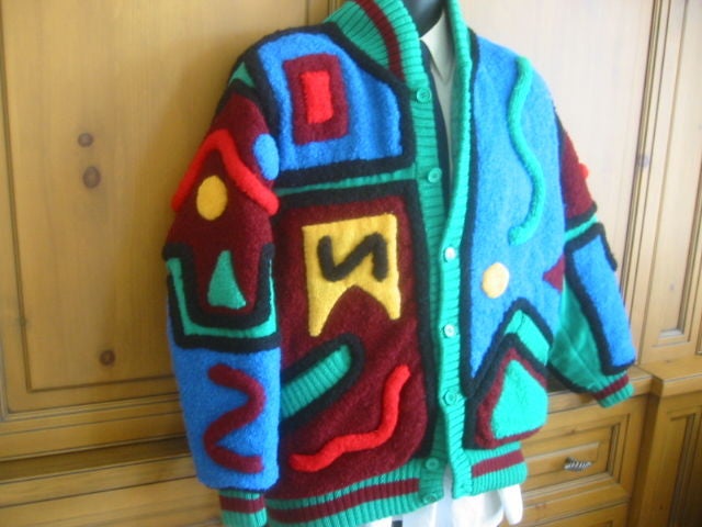 YAMAMOTO KANSAI Rare Collectible Jacket from 1981<br />
<br />
This jacket is made of boucle knit wool in a unique pattern in shades of green, blue, burgundy, yellow, red and black. It buttons in front and is trimmed with a ribbed knit. The collar