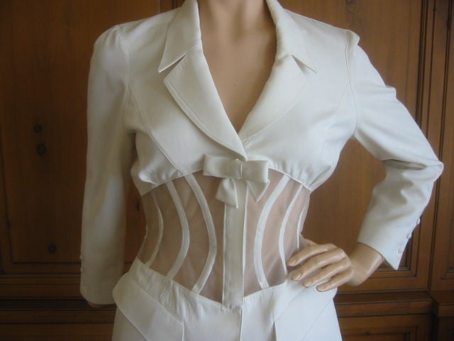 THIERRY MUGLER Sexy Vintage Boned Sheer Corset Jacket<br />
<br />
This fabulous jacket is made of polyester in a timeless shade of white. It's designed with a classic blazer silhouette with a sexy twist. The center of the bust is accented with a