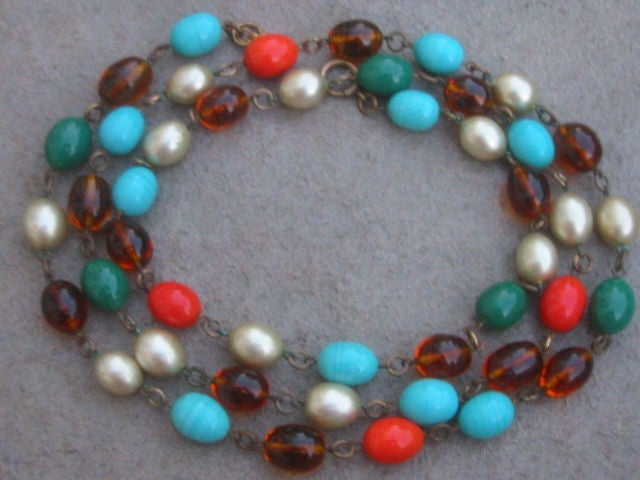 Lovely Vintage Beaded Necklace from Miriam Haskell<br />
<br />
This lovely necklace is made of turquoise, coral, green and amber glass beads and faux pearl beads. The beads are linked with antique brass findings. The necklace closes with a spring