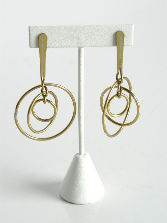 These Art Smith brass pendant earrings have a wonderful action to them. The three concentric brass rings spin and swing separately from each other. The simplicity of the 