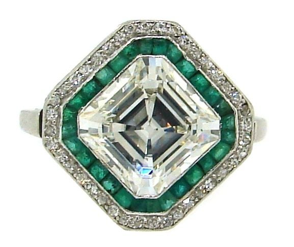 Beautiful Art Deco engagement ring with 3.79 cts Asscher cut diamond (GIA certified) tastefully accentuated with one row of French cut emeralds and one row of single cut diamonds. The setting is made of platinum.<br />
The ring is size 8.5 and can