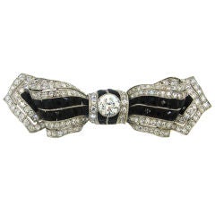 French Art Deco Black Onyx, Diamond 
Platinum Bow Brooch